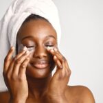 black-girl-with-towel-head-has-eye-patches-isolated-white-background